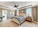 Spacious primary bedroom with tray ceiling, ceiling fan, carpet floors, and bright windows at 5380 Pembrey Dr # Lot 26, Denver, NC 28037