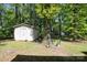 Backyard with mature trees, shed, and green grass at 5623 Eastbrook Rd, Charlotte, NC 28215