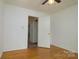 Bedroom with hardwood floors and neutral walls at 5623 Eastbrook Rd, Charlotte, NC 28215