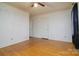 Bright bedroom with hardwood floors and neutral walls at 5623 Eastbrook Rd, Charlotte, NC 28215