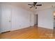 Spacious bedroom with hardwood floors, ceiling fan, and neutral walls at 5623 Eastbrook Rd, Charlotte, NC 28215