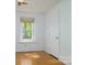 Bedroom featuring hardwood floors and a window providing natural light at 5623 Eastbrook Rd, Charlotte, NC 28215