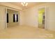 The dining room with neutral walls and carpet and doorway to kitchen at 5623 Eastbrook Rd, Charlotte, NC 28215