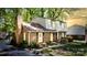 Charming two-story brick home with a well-maintained lawn, lovely landscaping, and shuttered windows at 5623 Eastbrook Rd, Charlotte, NC 28215