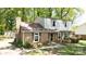 Traditional two-story brick house with a gambrel roof, shuttered windows, landscaping and mature trees at 5623 Eastbrook Rd, Charlotte, NC 28215