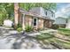 A classic brick home showcasing a lush, green lawn and well-maintained exterior details at 5623 Eastbrook Rd, Charlotte, NC 28215