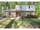 Inviting home with a brick facade, complemented by colorful landscaping and a cozy front porch at 5623 Eastbrook Rd, Charlotte, NC 28215