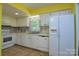 Bright kitchen with tile floor, and white cabinets at 5623 Eastbrook Rd, Charlotte, NC 28215