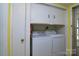 A laundry room with washer, dryer, cabinets, and storage at 5623 Eastbrook Rd, Charlotte, NC 28215