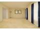 Spacious living room featuring neutral carpeting and light-filled windows at 5623 Eastbrook Rd, Charlotte, NC 28215