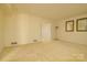Spacious living room featuring neutral carpeting and light-filled windows at 5623 Eastbrook Rd, Charlotte, NC 28215