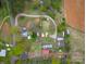 Aerial view of property with multiple structures and trees at 589 Lippard Farm Rd, Statesville, NC 28625