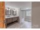 Bathroom featuring double vanity, updated fixtures, and a soaking tub at 589 Lippard Farm Rd, Statesville, NC 28625