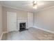Bedroom with gray flooring, fireplace and ceiling fan at 589 Lippard Farm Rd, Statesville, NC 28625