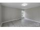 Serene bedroom with gray walls, light wood floors, and a bright window at 589 Lippard Farm Rd, Statesville, NC 28625