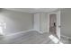 Comfortable bedroom with gray walls, light wood floors, and a closet at 589 Lippard Farm Rd, Statesville, NC 28625