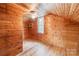 Wooden attic room with built-in shelves, fan and window at 589 Lippard Farm Rd, Statesville, NC 28625