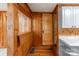 Vintage kitchen featuring knotty pine walls and a fold-down table at 589 Lippard Farm Rd, Statesville, NC 28625