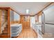 Charming kitchen with knotty pine walls, new white cabinets, and butcher block countertop at 589 Lippard Farm Rd, Statesville, NC 28625