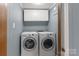 Laundry room with updated machines and storage at 589 Lippard Farm Rd, Statesville, NC 28625