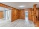 Living room showcasing sliding barn doors, knotty pine paneling, and updated floors at 589 Lippard Farm Rd, Statesville, NC 28625