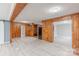 Spacious living room featuring wood paneling, light gray flooring, and open floor plan at 589 Lippard Farm Rd, Statesville, NC 28625