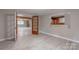 Open floor plan featuring gray walls, light gray flooring, and wood framed windows at 589 Lippard Farm Rd, Statesville, NC 28625