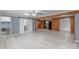 Open living room with wood accents, modern gray flooring, and laundry off to the side at 589 Lippard Farm Rd, Statesville, NC 28625