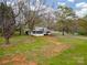 Back yard of home with covered parking and mature trees at 589 Lippard Farm Rd, Statesville, NC 28625