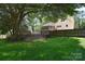 Expansive backyard featuring a large deck, mature trees, and a wooden privacy fence at 6008 Corkstone Dr, Mint Hill, NC 28227