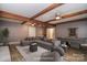 Virtually staged basement with exposed beam ceiling, and a gray sofa, pool table and chess table at 6008 Corkstone Dr, Mint Hill, NC 28227