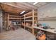 Unfinished basement with exposed ceiling, wood shelves, and concrete walls is great for storage space at 6008 Corkstone Dr, Mint Hill, NC 28227