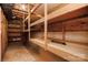Unfinished basement with exposed ceiling and wooden shelves is a blank canvas for all your storage needs at 6008 Corkstone Dr, Mint Hill, NC 28227