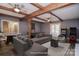 Virtually staged basement showcasing living space with pool table, large gray sofa, and bar area at 6008 Corkstone Dr, Mint Hill, NC 28227