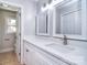 Bathroom features white double sink vanity, modern fixtures, and tile flooring at 6008 Corkstone Dr, Mint Hill, NC 28227