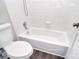 This bathroom features a bright white bathtub, toilet, and tile surround at 6008 Corkstone Dr, Mint Hill, NC 28227