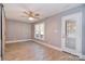 Bedroom features stylish flooring, bright windows, and a light ceiling fan at 6008 Corkstone Dr, Mint Hill, NC 28227
