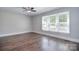 Spacious bedroom featuring natural light, ceiling fan and wood-look flooring at 6008 Corkstone Dr, Mint Hill, NC 28227