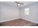 Bedroom with light grey walls, wood floors, a ceiling fan, and a window at 6008 Corkstone Dr, Mint Hill, NC 28227