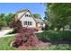 Charming two-story home with landscaped yard and a well maintained lawn at 6008 Corkstone Dr, Mint Hill, NC 28227