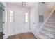 Bright foyer with a white front door, fresh paint, and a staircase at 6008 Corkstone Dr, Mint Hill, NC 28227