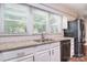 Bright kitchen features stainless steel appliances and a large window overlooking the backyard at 6008 Corkstone Dr, Mint Hill, NC 28227