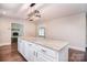 Bright kitchen featuring a center island, stainless steel appliances and a modern light fixture at 6008 Corkstone Dr, Mint Hill, NC 28227