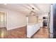 Bright kitchen featuring a center island, stainless steel appliances and a modern light fixture at 6008 Corkstone Dr, Mint Hill, NC 28227