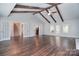 Bright and airy living room with hardwood floors, wood beams, fireplace, and multiple access points at 6008 Corkstone Dr, Mint Hill, NC 28227