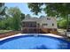 Inviting backyard pool and deck area with a screened porch perfect for outdoor entertaining at 6008 Corkstone Dr, Mint Hill, NC 28227