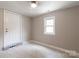 Empty bedroom features neutral paint, natural light through window and door with tile flooring at 606 W 19Th Ave, Gastonia, NC 28052