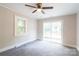Bright bedroom with a ceiling fan, and a sliding glass door that leads to the backyard at 606 W 19Th Ave, Gastonia, NC 28052