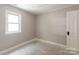 Neutrally painted bedroom with natural light features a large window and interior door at 606 W 19Th Ave, Gastonia, NC 28052