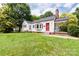 Charming single-Gathering home with red accents, mature trees, and a welcoming covered porch at 606 W 19Th Ave, Gastonia, NC 28052